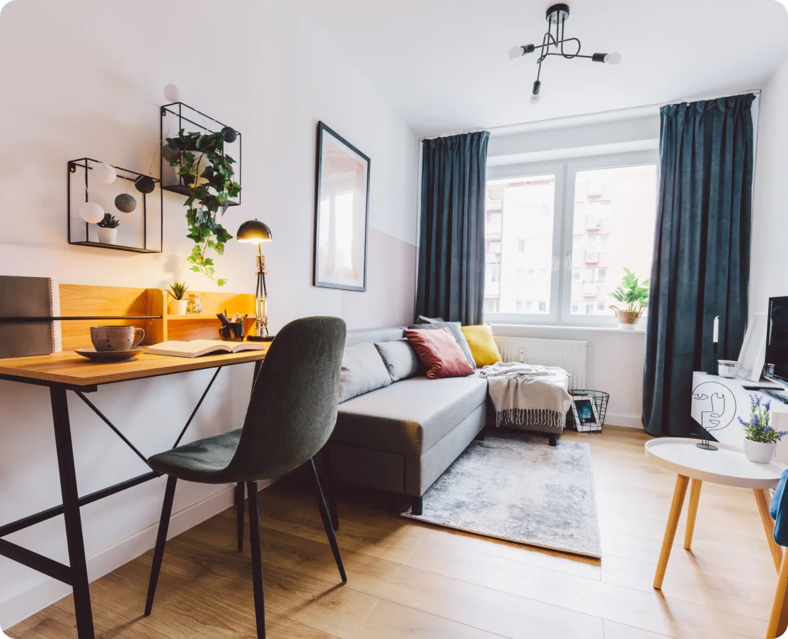 Modern apartment living room with workspace.